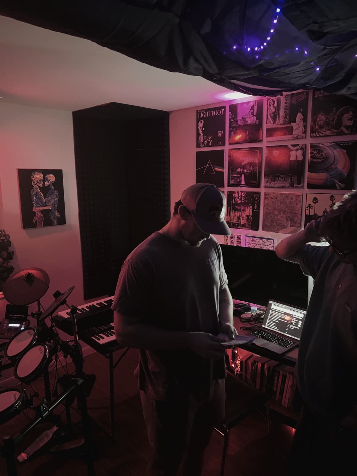 The e-drum kit and desk under red and purple light